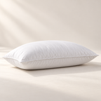 A single full white microfiber pillow shown in profile with a fine piped perimeter seam